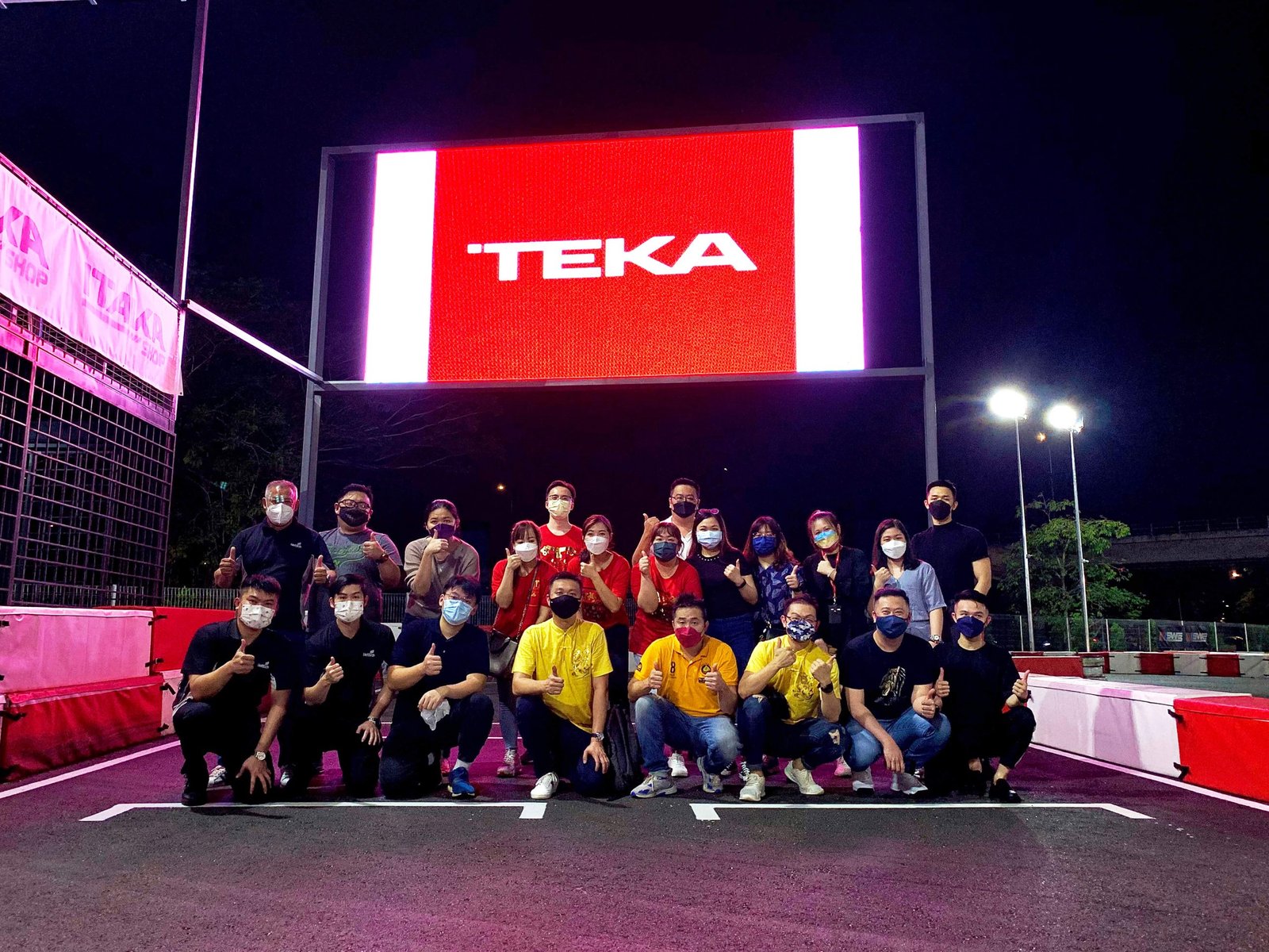 Morac Go Kart Track 1 Utama corporate event image with the members posing under the LED board. Their company logo is displayed on the board.